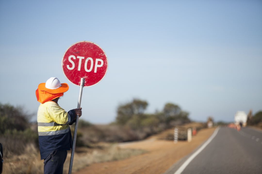 traffic management - Man holding stop sign